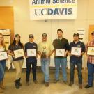 7 students holding their 2015 Collegiate Champions award